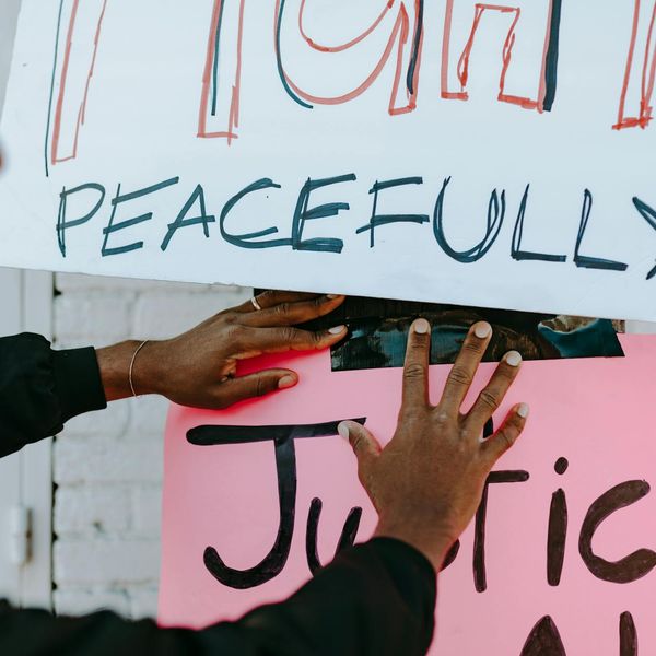 Person meditating peacefully in a calm, nature-inspired setting.